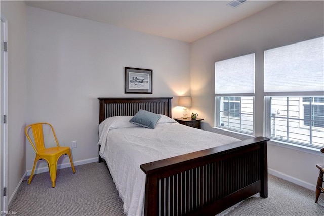 carpeted bedroom featuring baseboards