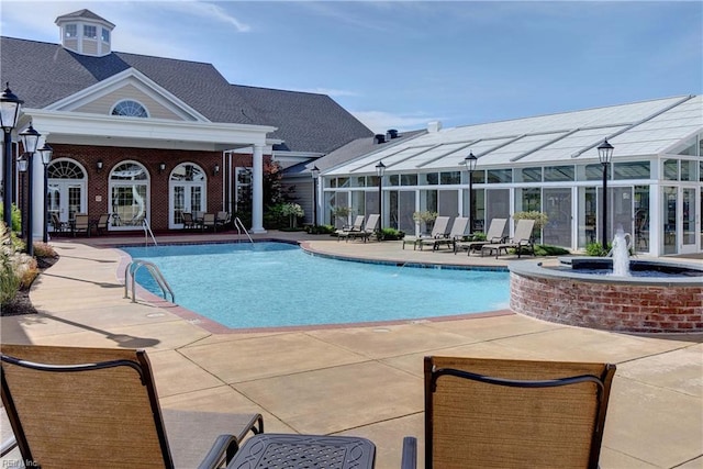 community pool featuring french doors and a patio