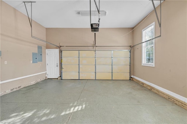 garage with a garage door opener, electric panel, and baseboards