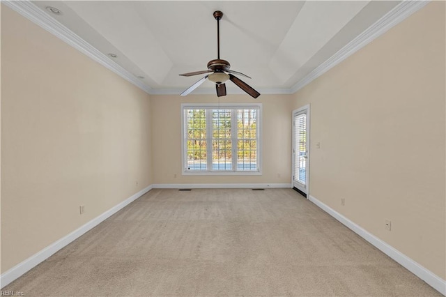 unfurnished room featuring a ceiling fan, light carpet, crown molding, and baseboards