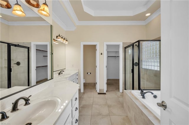 bathroom with a garden tub, a shower stall, ornamental molding, and vanity