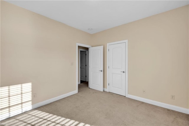 carpeted spare room with baseboards