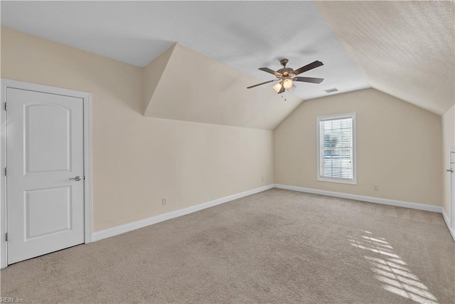 bonus room with carpet floors, lofted ceiling, visible vents, and baseboards