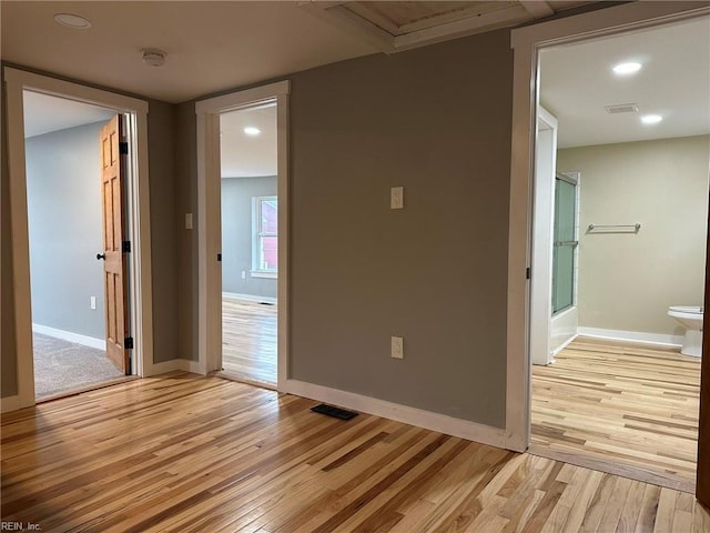 empty room with baseboards, recessed lighting, visible vents, and light wood-style floors