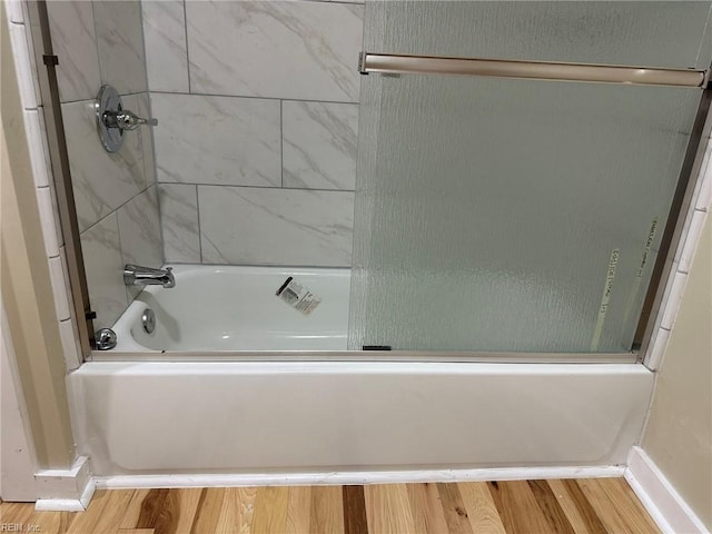 bathroom with bathtub / shower combination and wood finished floors