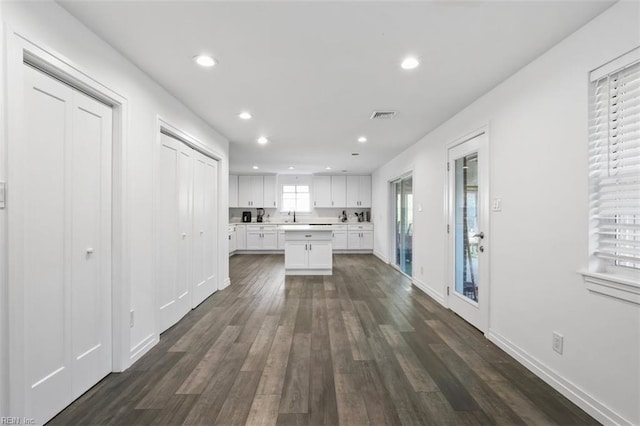 kitchen featuring visible vents, white cabinets, dark wood finished floors, light countertops, and recessed lighting