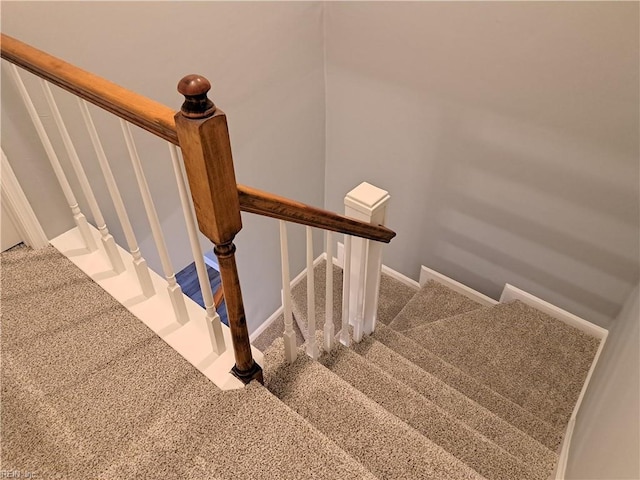 stairs with carpet floors and baseboards