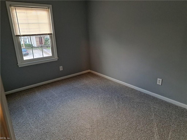 carpeted spare room with baseboards