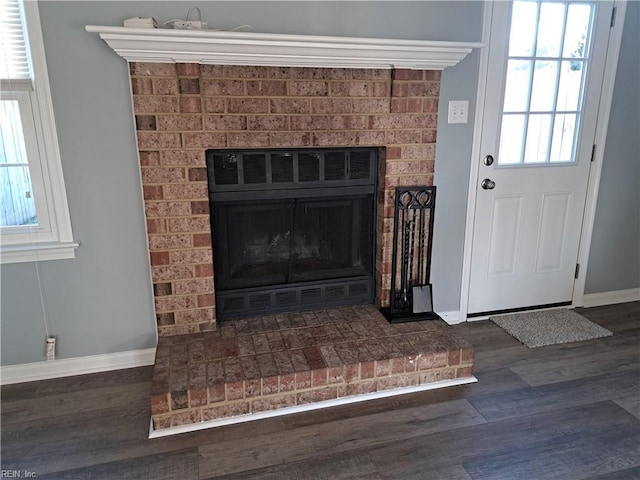 interior details featuring a fireplace, baseboards, and wood finished floors