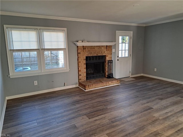 unfurnished living room featuring ornamental molding, a brick fireplace, dark wood finished floors, and baseboards