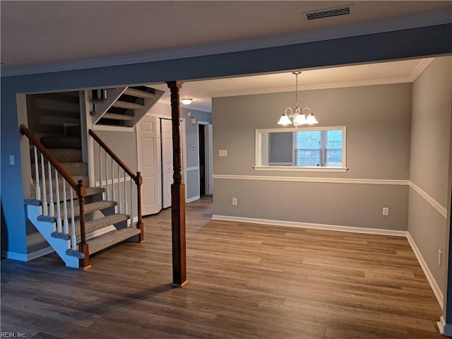 below grade area with wood finished floors, visible vents, baseboards, and stairs