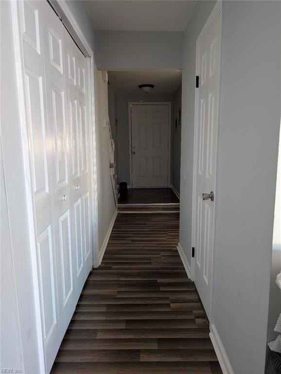 hall with dark wood finished floors and baseboards