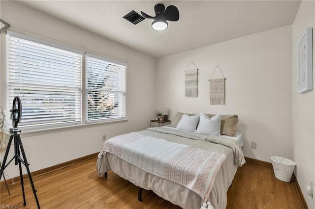 bedroom with light wood-style floors and baseboards