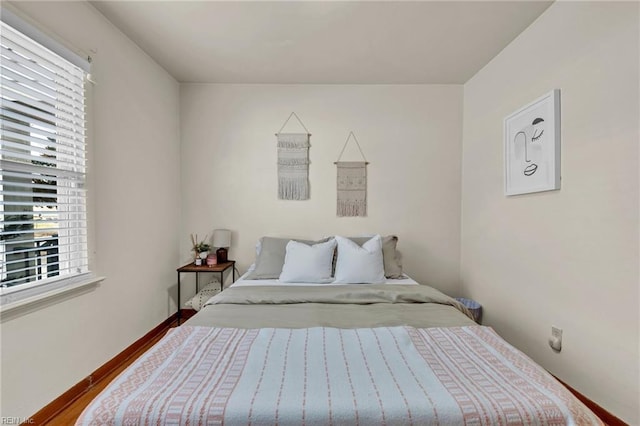 bedroom featuring baseboards and wood finished floors