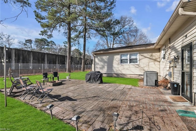 view of patio with an outdoor fire pit, central AC, and fence