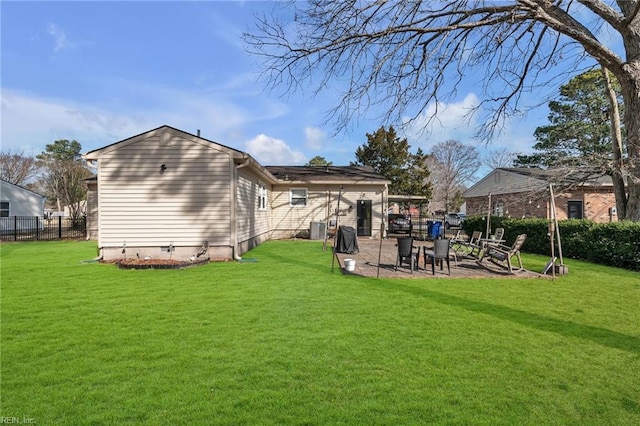 rear view of property featuring crawl space, a lawn, a patio, and fence