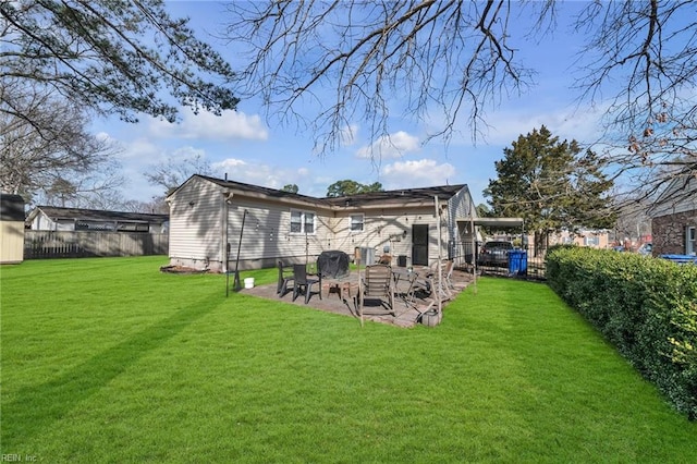 rear view of property with a lawn, a patio area, and a fenced backyard