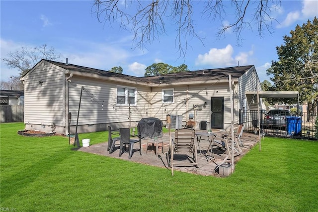 rear view of property featuring fence, a patio, and a yard