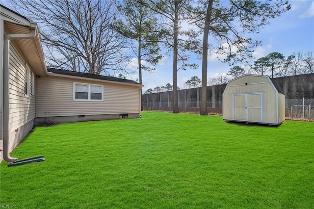 view of yard featuring a storage shed, fence, and an outdoor structure