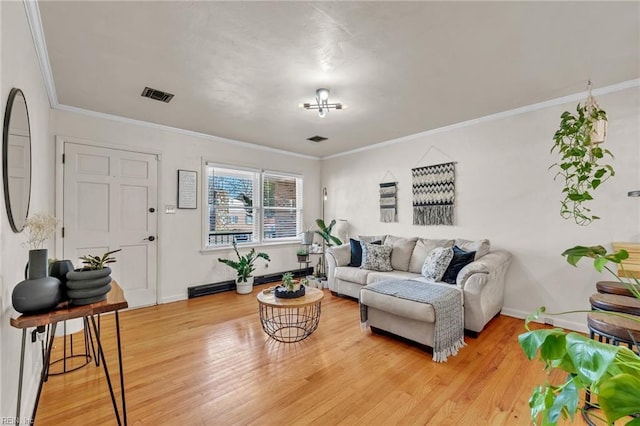 living room with a baseboard heating unit, visible vents, light wood-style flooring, and baseboards