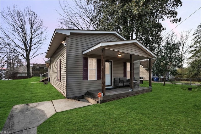 view of front of home with a porch and a front lawn