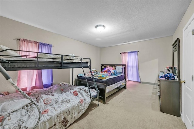 carpeted bedroom featuring a textured ceiling