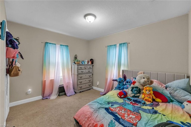 carpeted bedroom featuring baseboards