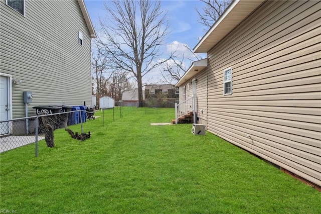 view of yard with entry steps and fence