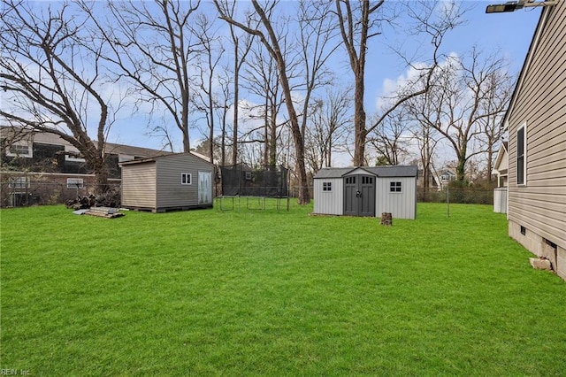 view of yard with a storage shed, a fenced backyard, and an outdoor structure