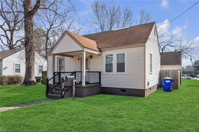 view of front facade with crawl space, a porch, a front lawn, and roof with shingles