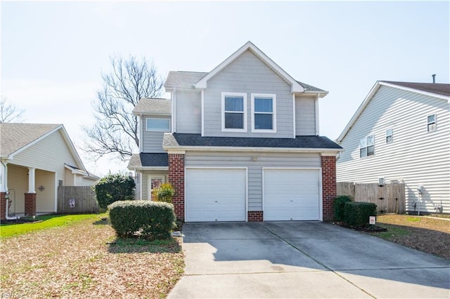 view of front of house with an attached garage, driveway, fence, and brick siding