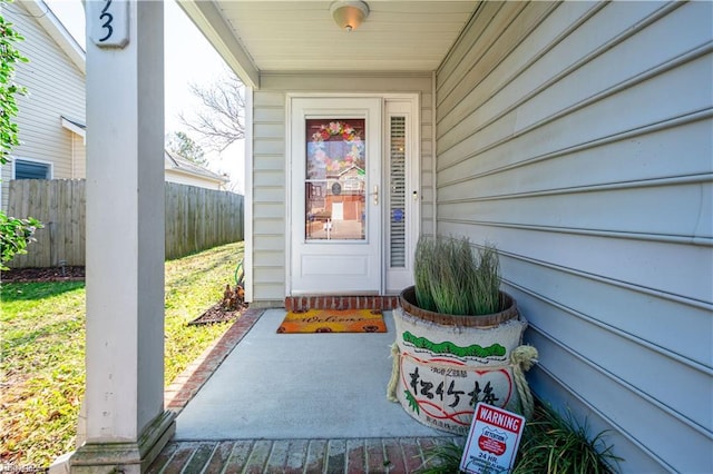 doorway to property featuring fence