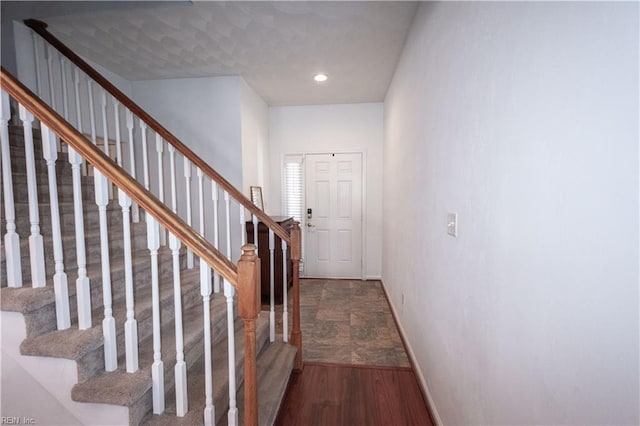 foyer entrance with recessed lighting, stairway, baseboards, and wood finished floors