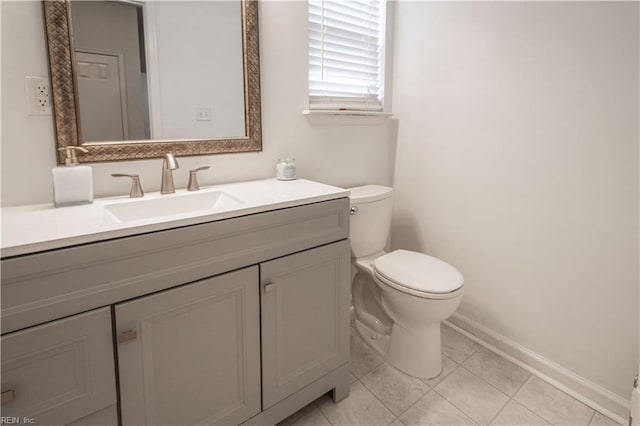 bathroom featuring baseboards, vanity, toilet, and tile patterned floors