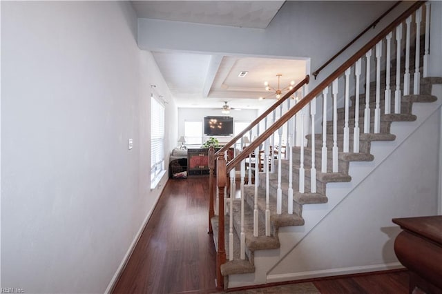 stairs with wood finished floors and baseboards