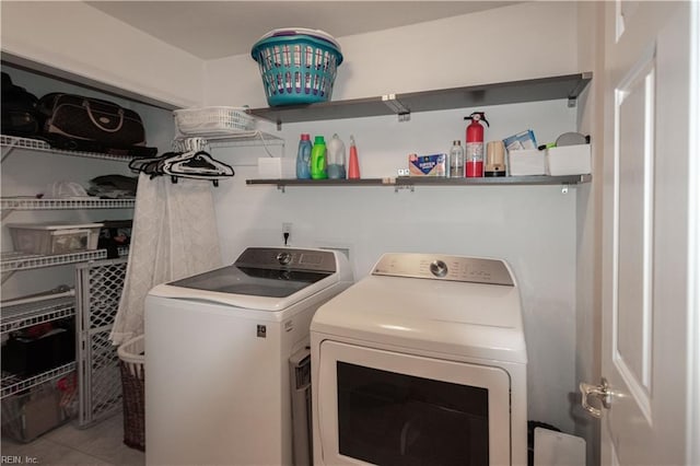 clothes washing area featuring laundry area, tile patterned flooring, and independent washer and dryer