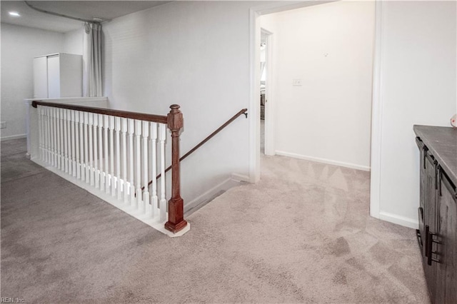 staircase with baseboards and carpet flooring