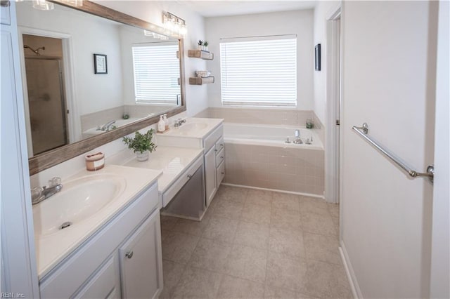 bathroom featuring a shower with door, a bath, and vanity