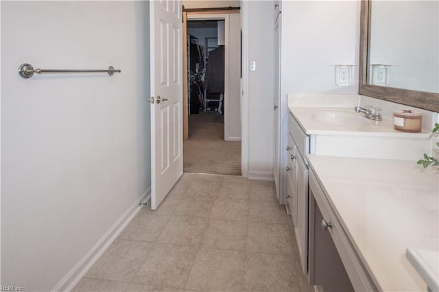 bathroom featuring baseboards and vanity