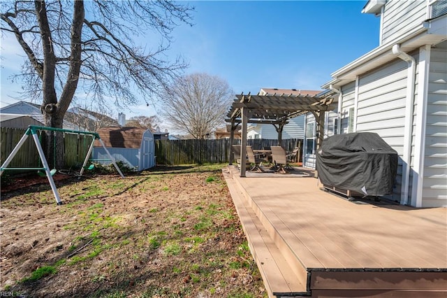 view of yard with outdoor dining space, a fenced backyard, an outdoor structure, and a pergola