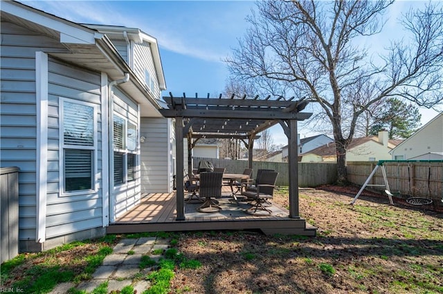 view of yard featuring outdoor dining area, a fenced backyard, a wooden deck, and a pergola