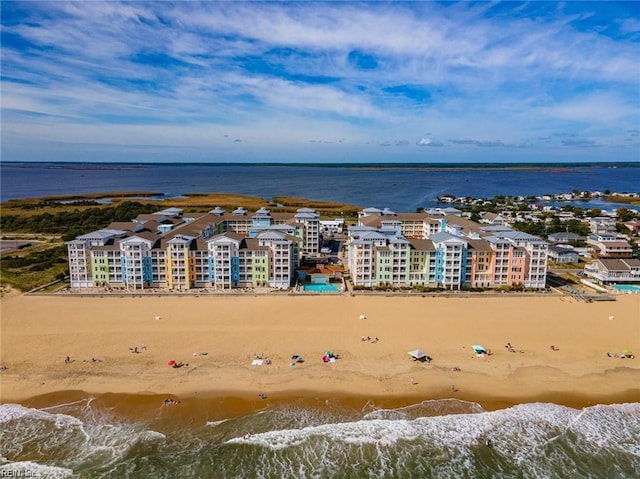 drone / aerial view with a water view and a beach view