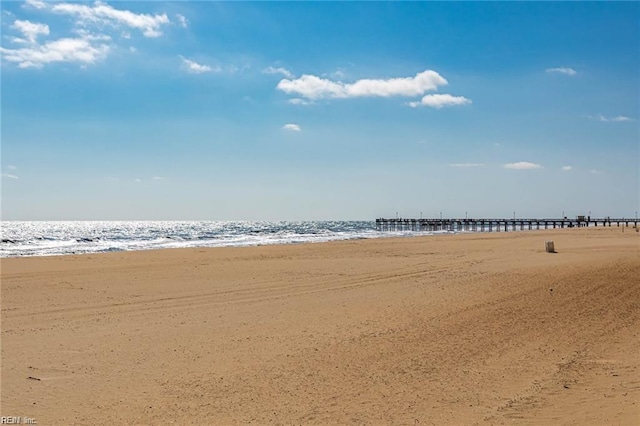 exterior space with a water view and a view of the beach