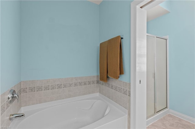 full bath featuring a garden tub and a shower stall