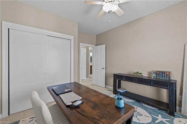 office featuring a ceiling fan, carpet flooring, and baseboards