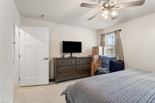 bedroom with ceiling fan, visible vents, and light carpet