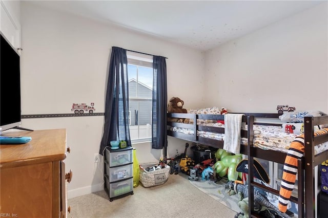 carpeted bedroom featuring baseboards