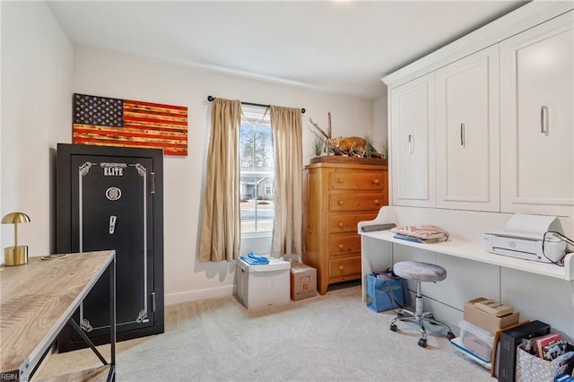 home office with baseboards and light carpet