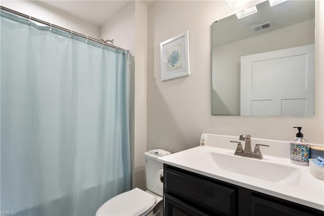 bathroom with vanity, curtained shower, toilet, and visible vents