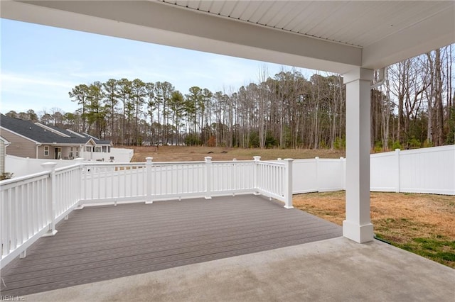 view of patio featuring a deck and fence